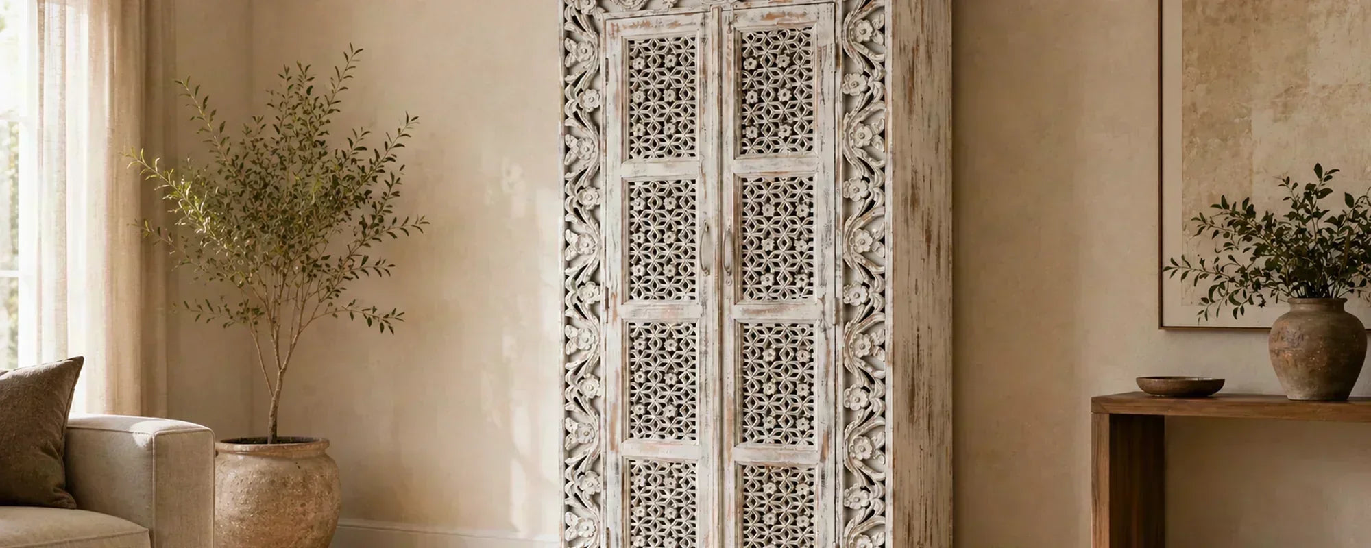 Distressed White Carved Wooden Cabinet in a Warm Neutral Living Room Interior.  
