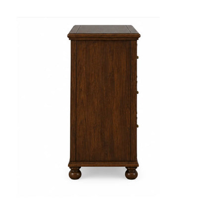 Side profile of Winnetka carved dresser showing molded top edge and bun feet